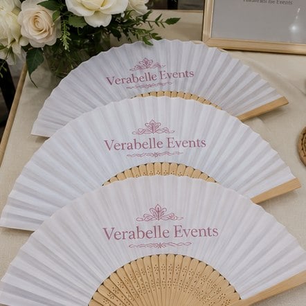 Branded hand fans with logo on a display table