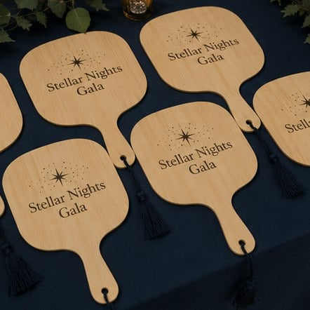 Printed paddle fans arranged before an event